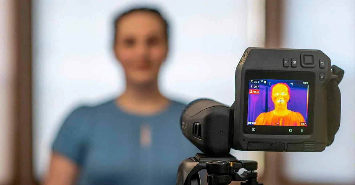 A FLIR thermal imaging camera is used to measure elevated body temperature.