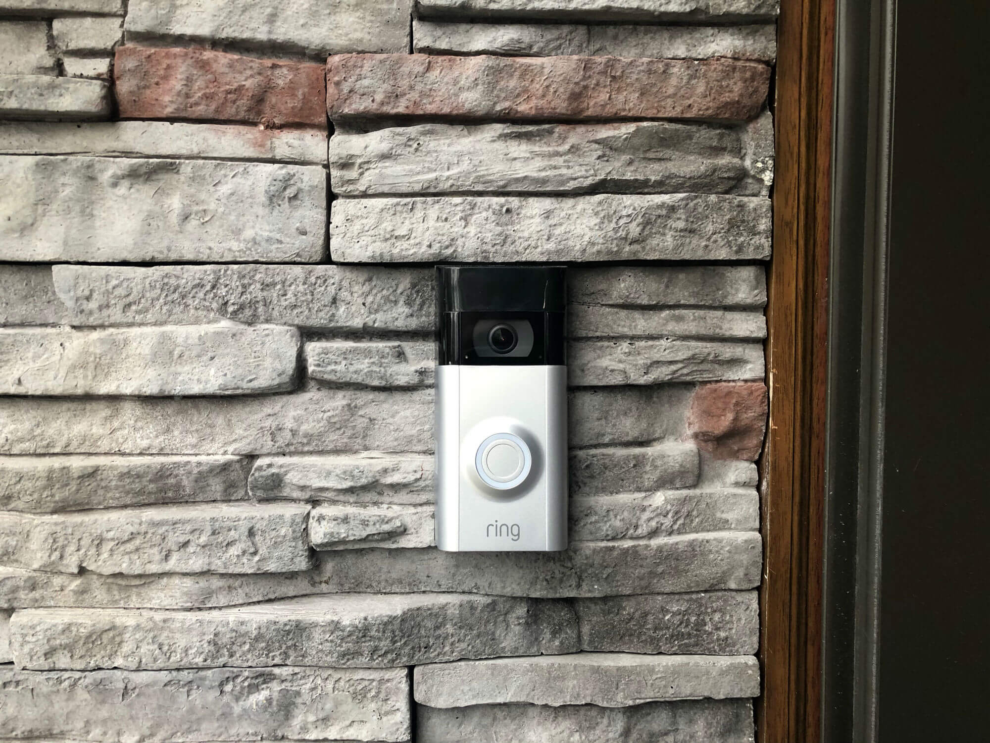 Ring Video Doorbell 2 mounted on a stone wall.