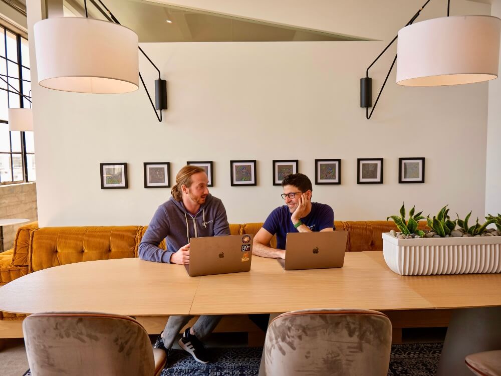 Two men having a conversation in a community space.