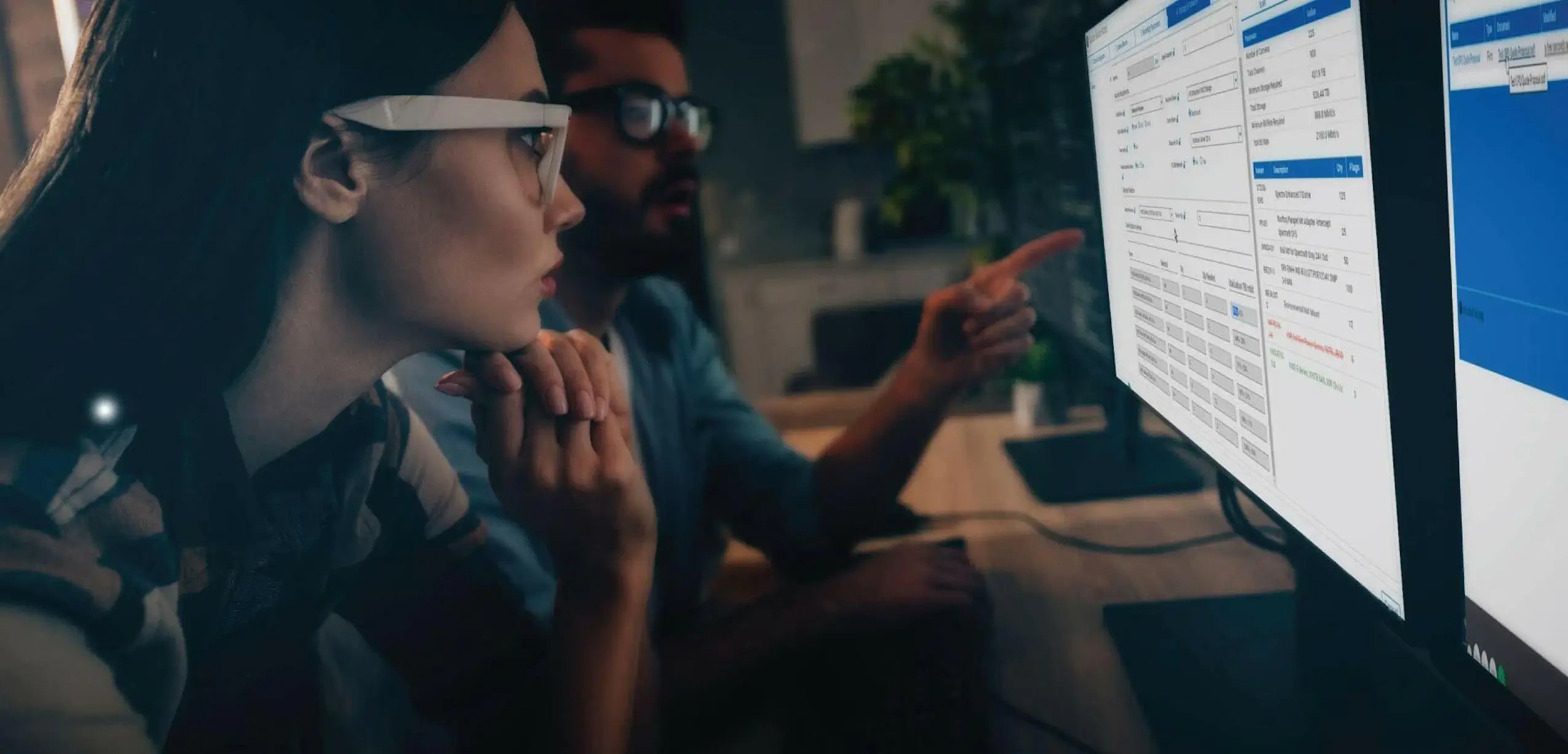 A man and a women reviewing security camera footage.